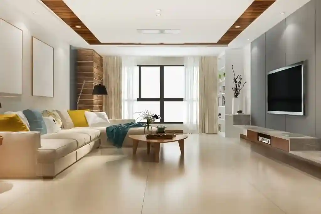 Modern luxury living room design featuring a grey TV wall panel, custom wooden ceiling accents, and contemporary furniture, executed by a leading interior design company in Dubai.